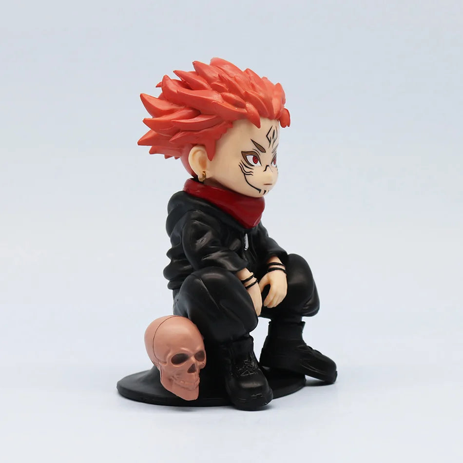 Figurine chibi de profil, uniforme noir, col rouge, cheveux orange, crâne au sol