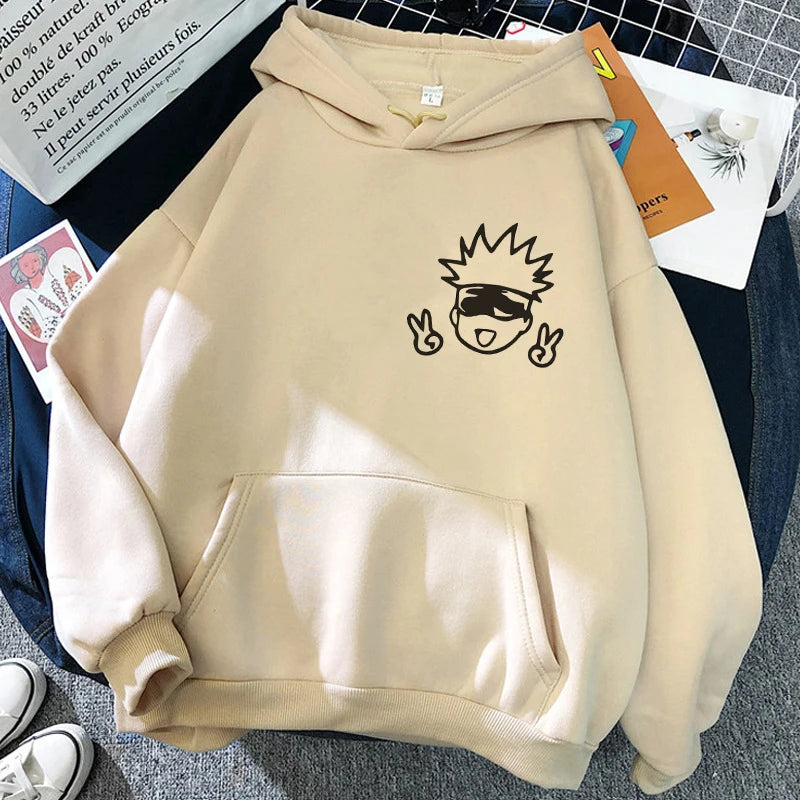 Sweat à capuche beige, grande poche kangourou et personnage noir style cartoon sur le devant