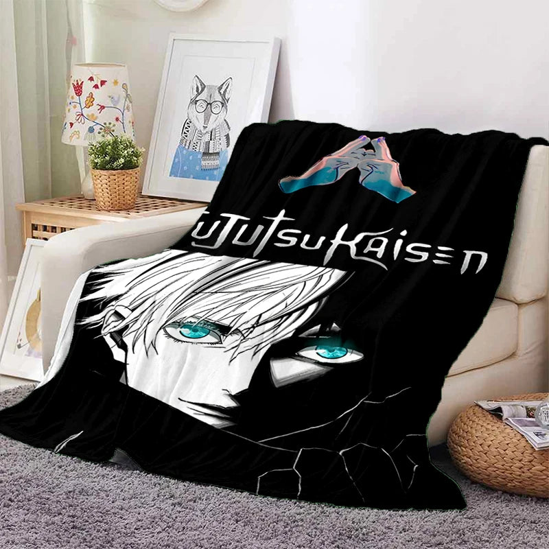 Couverture noire en tissu doux avec visages anime bleu-vert et texte décoratif
