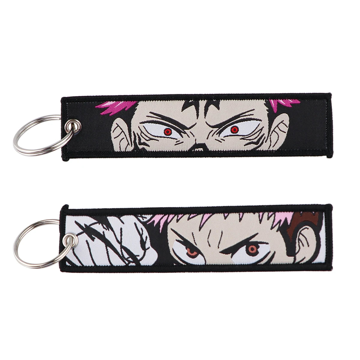 Porte-clés Jujutsu Kaisen Yuji x Sukuna Regard Rouge : en tissu noir avec visages anime, yeux rouges, surlignes violets, anneaux
